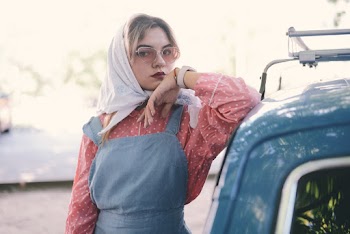 Woman Leaning on a Blue Car
