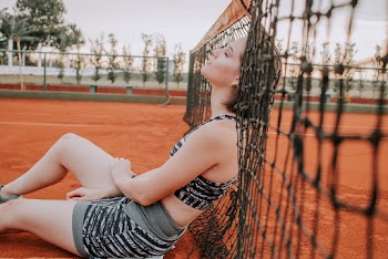 Woman Leaning On A Net