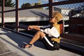 Woman Leaning On A Wire Fence