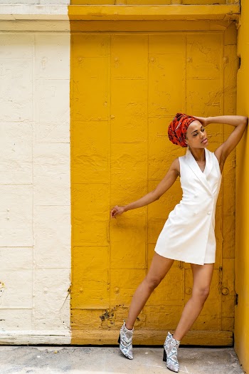 Woman Leaning On A Yellow Painted Wall