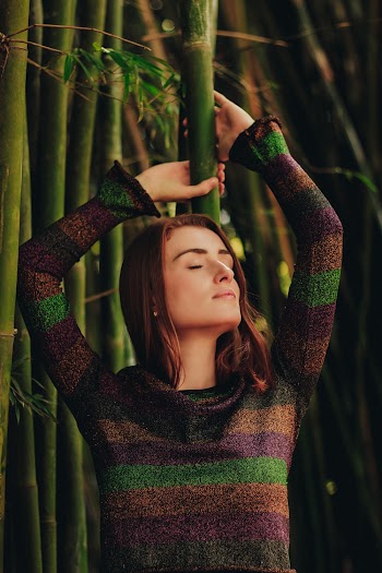 Woman Leaning On Bamboo