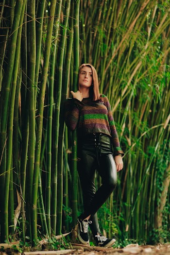 Woman Leaning On Bamboos