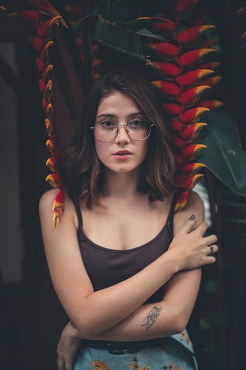 Woman Leaning on Birds of Paradise Flowers