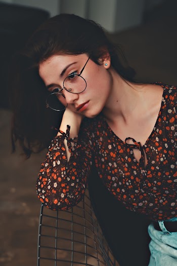 Woman Leaning on Black Metal Fence
