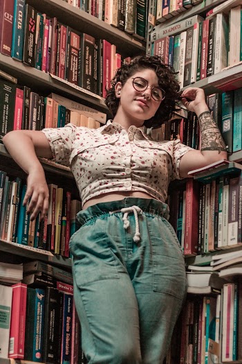 Woman Leaning on Bookshelf
