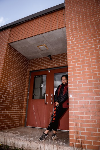 Woman Leaning On Brick Wall
