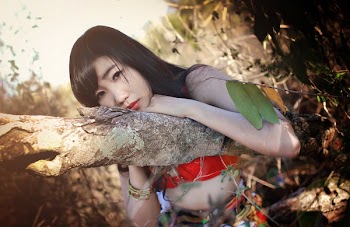 Woman Leaning on Brown Branch