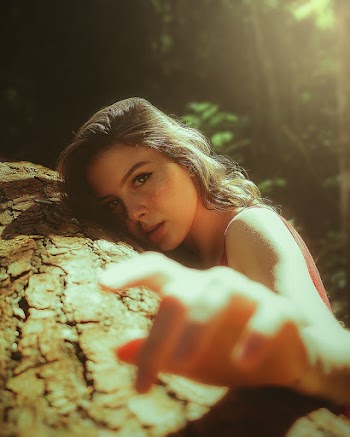 Woman Leaning on Brown Log