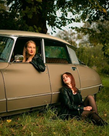 Woman Leaning On Brown Sedan