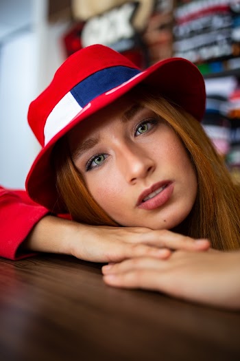 Woman Leaning on Brown Surface