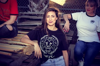 Woman Leaning on Brown Wooden Board Beside Woman Wearing White Crew-neck Shirt