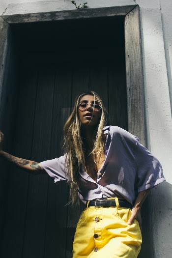 Woman Leaning on Brown Wooden Door Frame