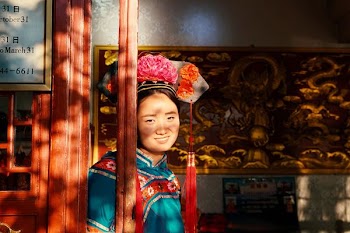 woman leaning on brown wooden wall at daytime