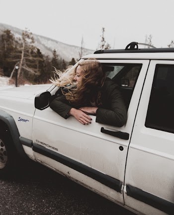 Woman Leaning on Car Window