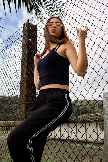 Woman Leaning on Chain-link Fence