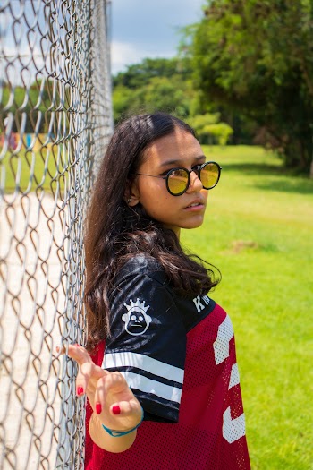 Woman Leaning On Chain-link Fence