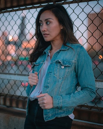 Woman Leaning on Chain-link Fence