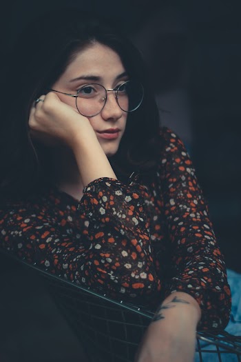 Woman Leaning on Chair Looking Sideward