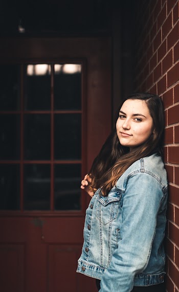 Woman Leaning on Concrete Brick Wall