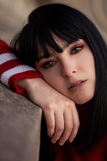Woman Leaning On Concrete Surface