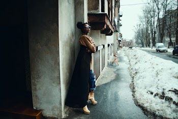 Woman Leaning on Concrete Wall