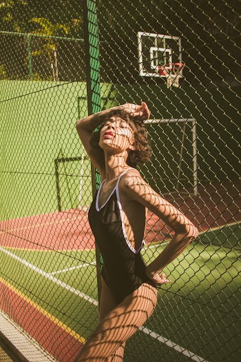 Woman Leaning on Fence