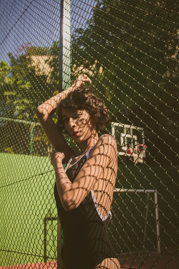 Woman Leaning on Fence