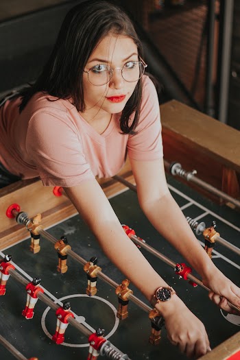 Woman Leaning on Foosball