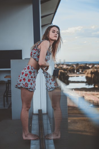 Woman Leaning on Glass Safety Rail