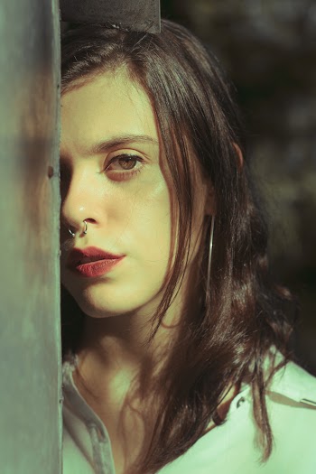 Woman Leaning on Glass Wall