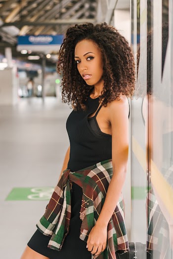 Woman Leaning on Glass Wall