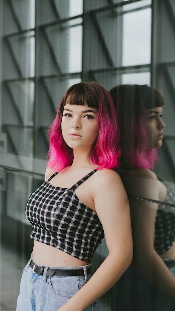 Woman Leaning on Glass Wall