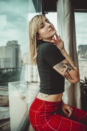 Woman Leaning on Glass Wall
