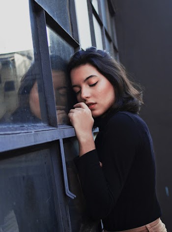 Woman Leaning on Glass Window