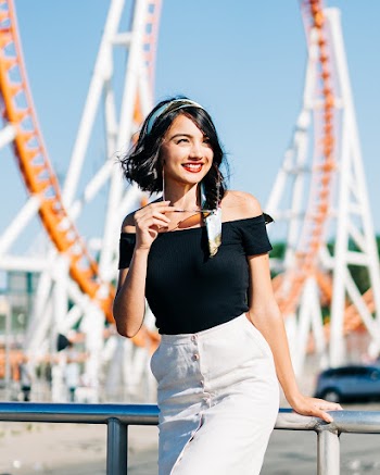 Woman Leaning on Gray Stainless Steel Railings Laughing