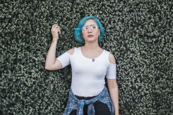 Woman Leaning on Green and Beige Wall