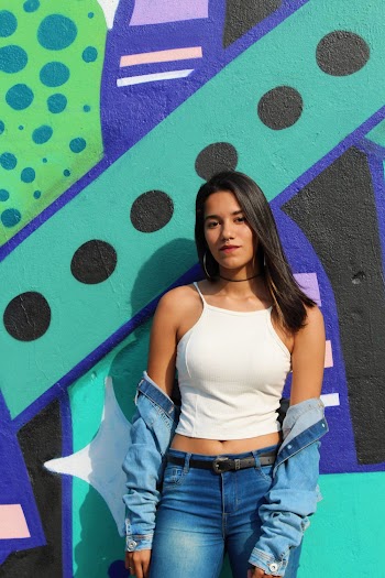 Woman Leaning on Green and Black Wall