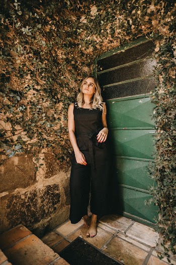 Woman Leaning On Green Gate