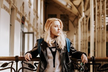Woman Leaning On Hand Rail