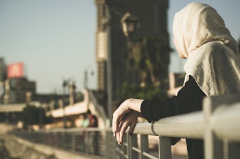 Woman Leaning on Hand Rails