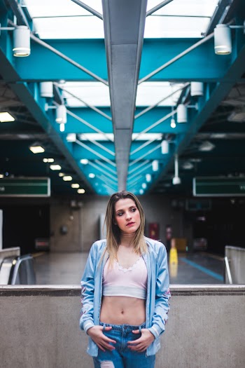 Woman Leaning on Handrail Inside Building