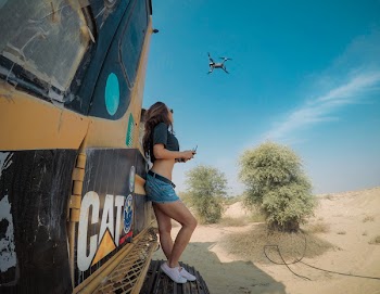 Woman Leaning on Heavy Equipment
