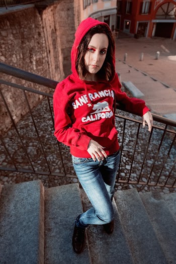 Woman Leaning on Metal Baluster