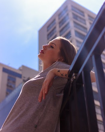 Woman Leaning On Metal Frame