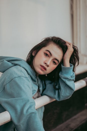 Woman Leaning on Metal Handrail
