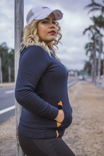 Woman Leaning on Metal Pole
