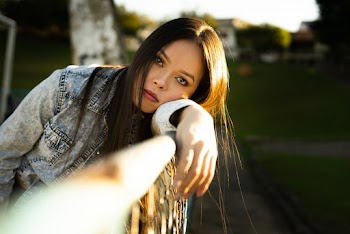 Woman Leaning on Metal Rail