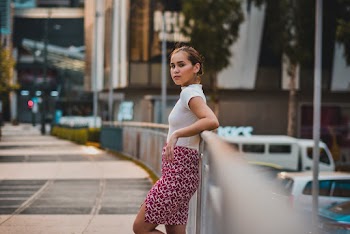 Woman Leaning On Metal Rail