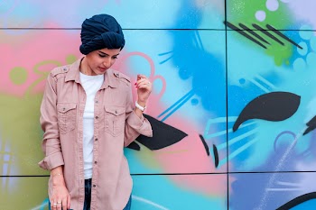 Woman Leaning on Multicolored Wall