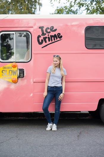 Woman Leaning on Pink Vehicle